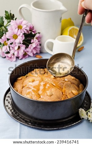 Basbousa (namoora) - arabian semolina cake with almonds and honey syrup on cotton background