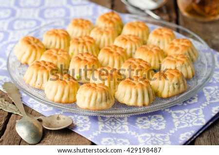 Maamoul or mamoul - arabic cookies stuffed dates with icing cugar on vintage wooden table background. Selective focus