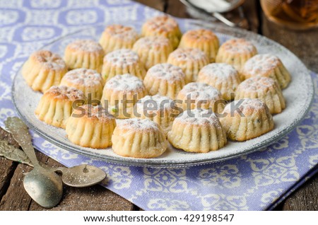 Maamoul or mamoul - arabic cookies stuffed dates with icing cugar on vintage wooden table background. Selective focus