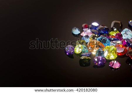 Jewel on black shine color, Collection of many different natural gemstones \
amethyst, lapis lazuli, rose quartz, citrine, ruby, amazonite, moonstone, labradorite, chalcedony, blue topaz