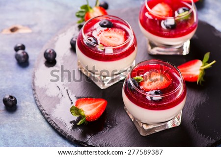 Dessert panna cotta with fresh berries on wooden background, selective focus