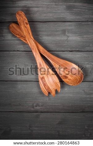Kitchen utensils: wooden spoon and fork. Selective focus, top view. Toned image