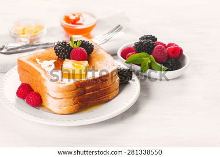 French toast with honey, butter and fresh berries, selective focus