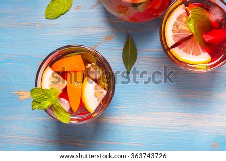 Refreshing summer cocktails with citrus fruits over blue vintage table. Top view. Selective focus