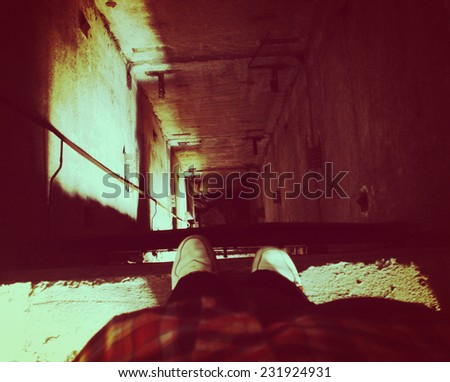 A person stands on the edge near the elevator shaft.  Thinking about life and death, problems, hopelessness, stress