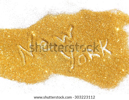Blurry inscription New York on golden glitter sparkle on white background