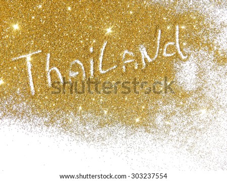 Blurry inscription Thailand on golden glitter sparkles on white background