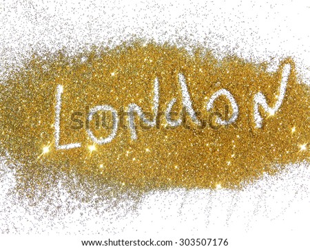 Inscription London on golden glitter sparkles on white background