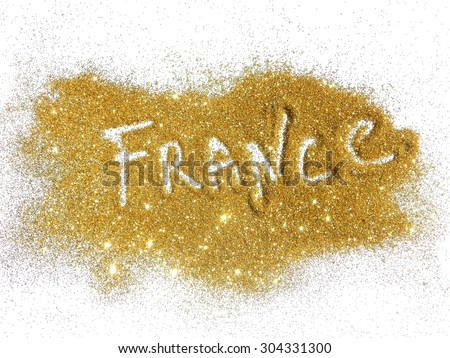Blurry inscription France on golden glitter sparkles on white background