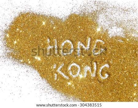 Inscription Hong Kong on golden glitter sparkles on white background