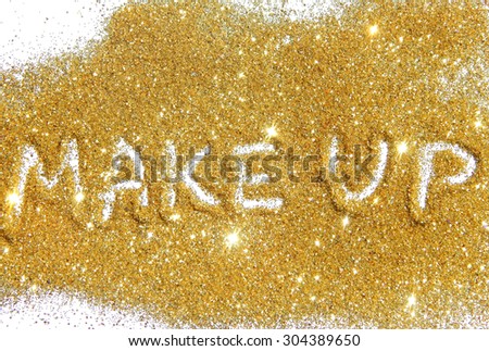 Inscription Make Up on gold glitter sparkle on white background
