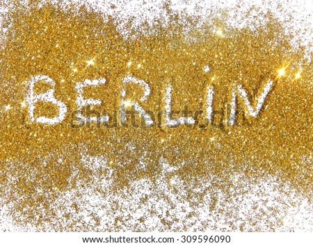 Inscription Berlin on golden glitter sparkles on white background