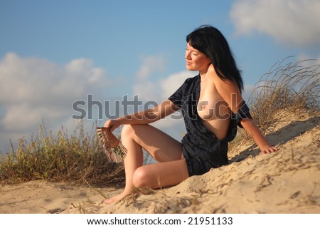 stock photo Exotic Asian nude model relaxing at sunset beach