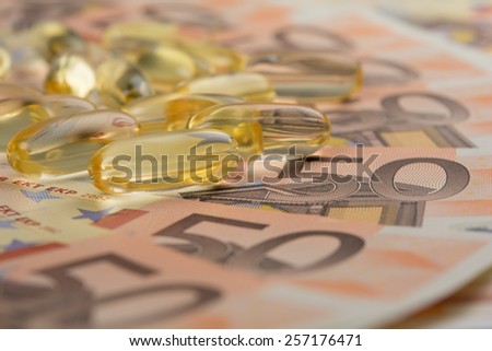 Gel capsules and money in drug expense concept