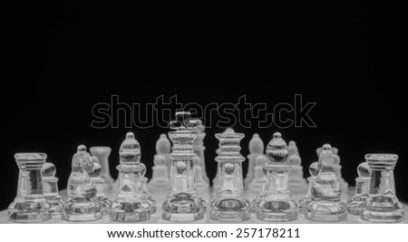 Glass chess game, black and white, shallow depth of field