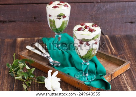 Tiramisu in a glass of tea match and cherry