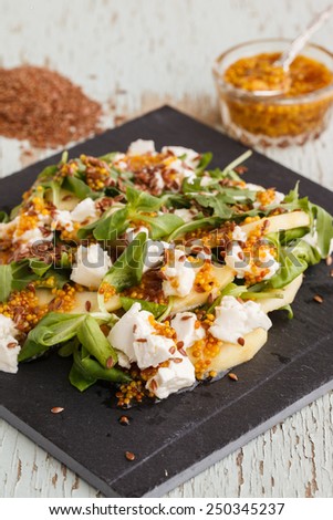 Salad with apples,cheese and herbs, seasoned with mustard sauce.