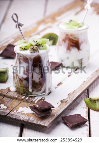Yogurt with kiwi and chocolate,cooked in glass jars.