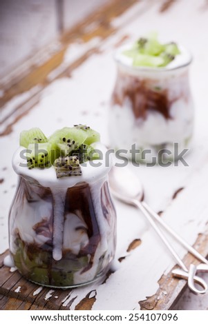 Yogurt with kiwi and chocolate,cooked in glass jars.