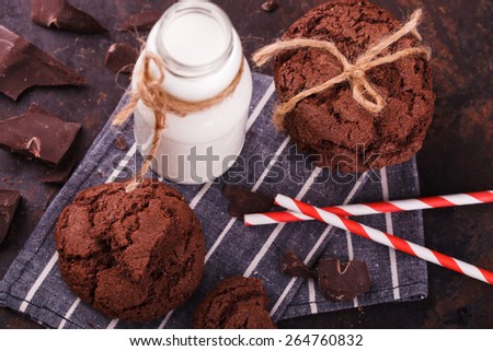 Chocolate chip cookies with milk and chocolate on a dark background.selective focus