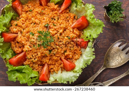 Kisir, traditional turkishr salad, Bulgur wheat   prepared with tomato paste, fresh tomatoes, parsley, olive oil.selective focus