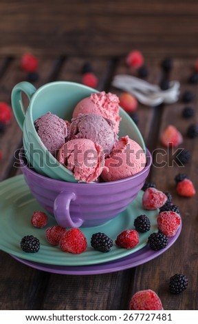 Ice cream BlackBerry and strawberry in the shape of a ball, with fresh berries.selective focus