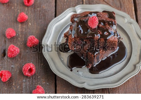 Chocolate brownie with raspberries in chocolate glaze.selective focus