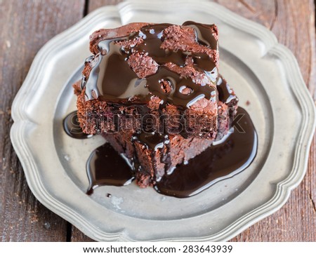 Chocolate brownie with raspberries in chocolate glaze.selective focus