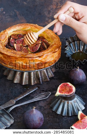 Cake with figs and honey of flaky pastry, on a dark background. selective focus