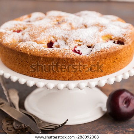 Pie with plums in powdered sugar.selective focus