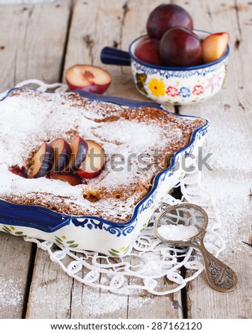 Plum cake in the shape  with powdered sugar.selective focus