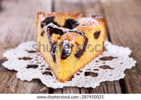 A piece of plum cake in powdered sugar