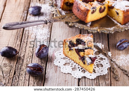 Plum cake with powdered sugar and a Cup of coffee.selective focus