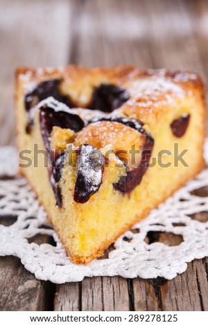 A piece of plum cake in powdered sugar