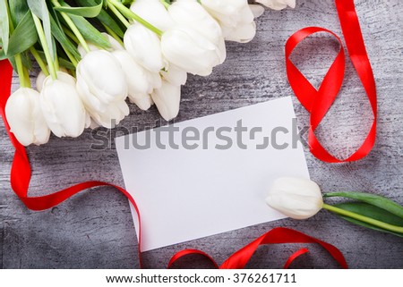 Bouquet white tulips with red ribbon.Flowers of spring and love.Happy Mothers Day.Copy space.selective focus.