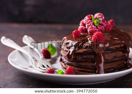 Chocolate pancake with chocolate glaze,raspberries and mint.selective focus