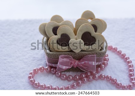 Pretty Rolled Chocolate Heart inside Vanilla Heart Sugar Cookies in a Ceramic bowl wraps with Burlap
