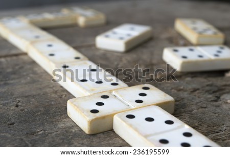 Playing old domino game on wood background