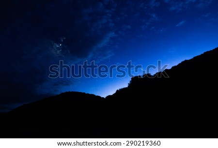 Silhouette of mountains in sunset time and view of the night sky
