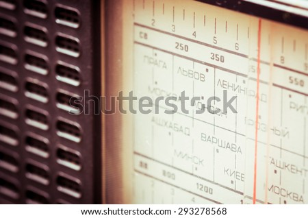 Close up photo of soviet radio. On the panel are listed the names of cities and capitals of the Soviet Union and Europe in Russian, such as Moscow, Kiev, Lviv, Minsk, Warsaw