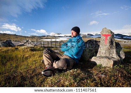Hiker with hiking signs in Norway - Hardangervidda