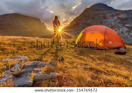 Hiker In The Sunrise With Tent