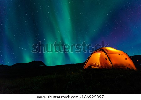 Illuminated Tent And Northern Lights