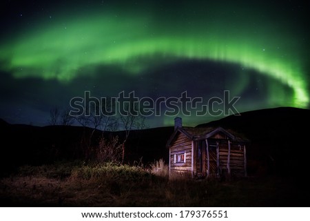 northern lights over a cabin in sweden