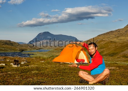 Hiker with tent on a camp in the wilderness of sweden