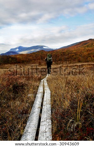 A Hiker on the Kungsleden - the long distance hiking trail in northern sweden scandinavia The Trail and not the wanderer is in the focus