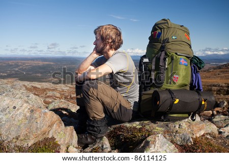 Long distance hiker have a break on the top of the mountain