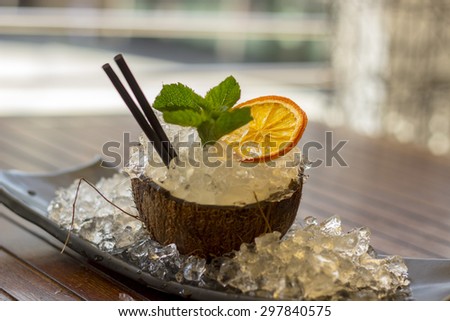 Cocktail with white rum in a coconut with pineapple juice