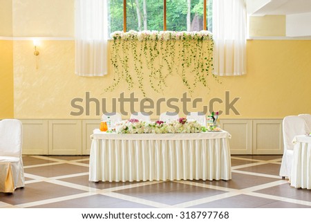 decorated wedding table for newlyweds in the restaurant