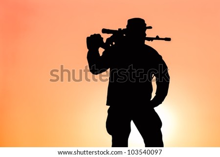 silhouette of a soldier with a background sunset